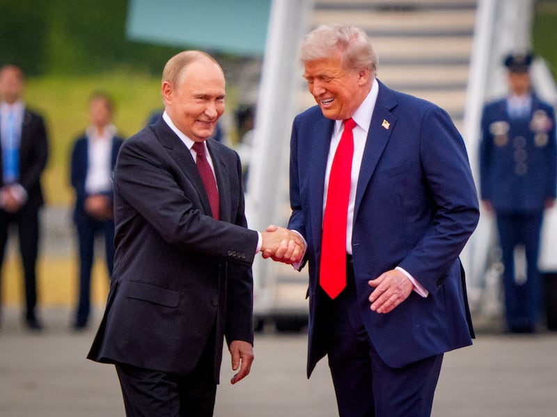 U.S. President Donald Trump (R) greets Russian President Vladimir Putin as he arrives at Joint Base Elmendorf-Richardson on August 15, 2025 in Anchorage, Alaska.