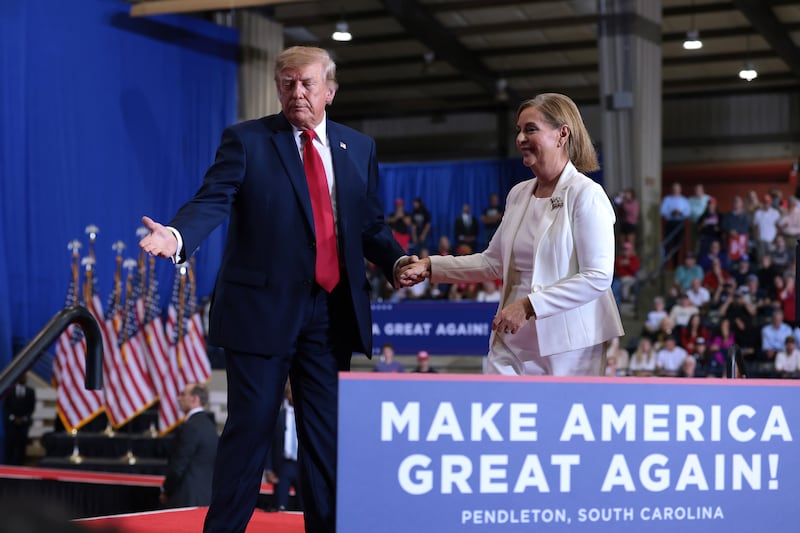 PENDLETON, SOUTH CAROLINA - OCTOBER 21: U.S. President Donald Trump escorts Republican U.S. Senate nominee Sen. Darline Graham (R-SC) off the stage during a campaign rally at T. Ed Garrison Arena at Clemson University on October 21, 2026 in Pendleton, South Carolina. President Trump is in South Carolina rallying support for local Republican candidates. (Photo by Anna Moneymaker/Getty Images)