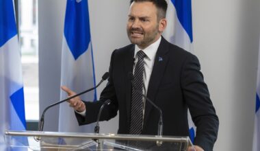Man speaks into mic while on a podium
