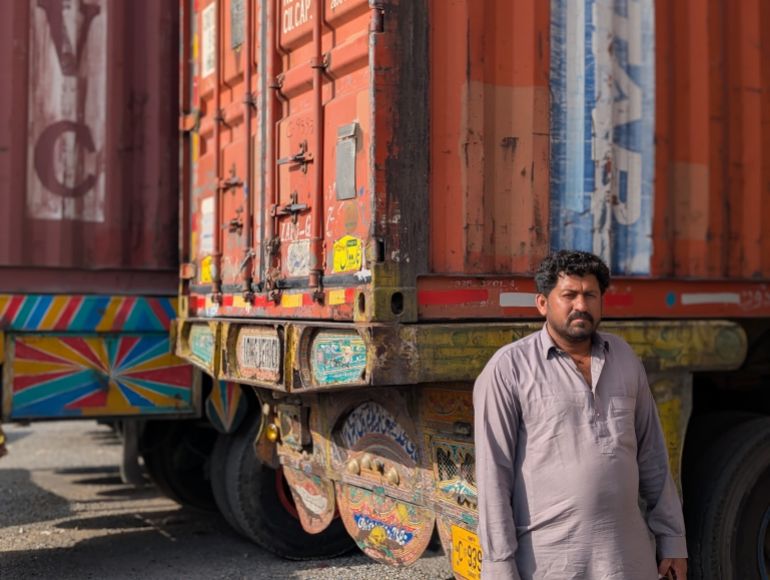 Muhammad Saleem Jaffar stands beside his truck near Islamabad’s fruit and vegetable market where his vehicle has been kept since early September