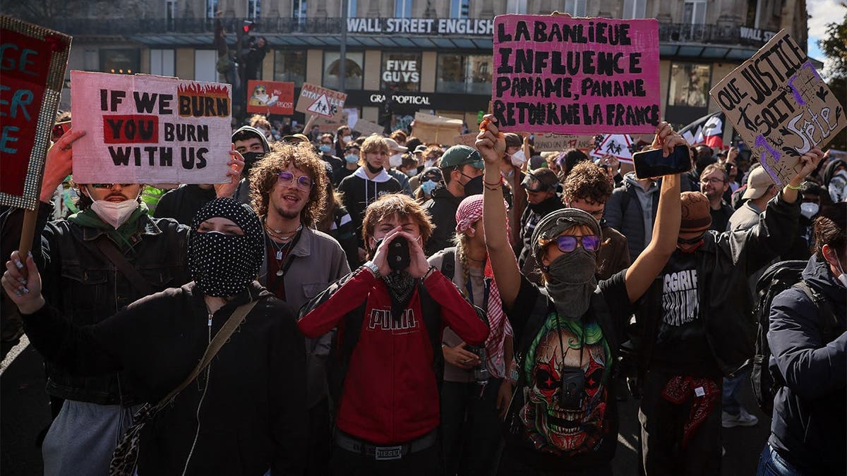 French protests with protesters holding signs that read: 