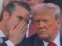 U.S. Secretary of Defense Pete Hegseth talks to U.S. President Donald Trump during the U.S. Army's 250th Birthday parade, on the same day of U.S. President Donald Trump 79th birthday, in Washington, D.C., U.S., June 14, 2025. REUTERS/Carlos Barria     TPX IMAGES OF THE DAY