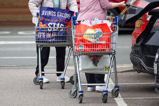 Customers prepare to load their shopping in to a car outside a supermarket in Chelmsford, UK, on Tuesday, March 24, 2026. UK??inflation??held at an 11-month low before the war in Iran sent petrol costs soaring and threatened to deliver another shock to household finances. Photographer: Chris Ratcliffe/Bloomberg via Getty Images