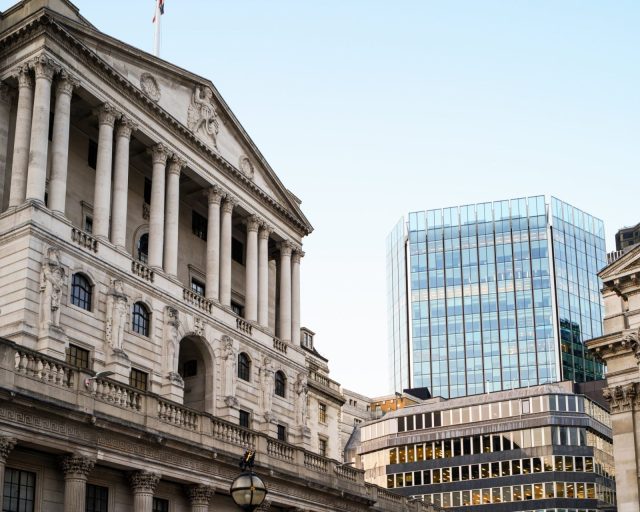 UK, low angle view of Bank of England with view of modern office buildings behind