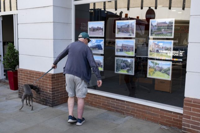 Man looking into the window of an estate agent on 11th August 2026 in Shrewsbury, United Kingdom. Housing in the UK is a very important contributing factor and measure in the economy as house prices and the property market continues to rise, pricing many people of lower incomes out of owning their own homes. (photo by Mike Kemp/In Pictures via Getty Images)
