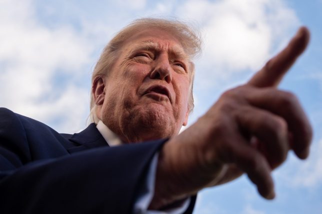 President Donald Trump points while speaking to reporters before boarding Marine One on the South Lawn of the White House, Monday, Oct. 12, 2026, in Washington. (AP Photo/Julia Demaree Nikhinson)