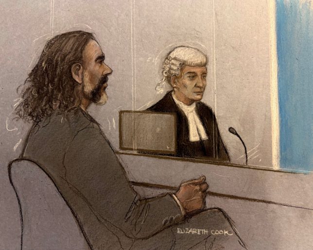 Court artist sketch by Elizabeth Cook of Russell Brand and barrister Riel Carney-Jones KC listening to witness evidence being given from behind the blue screen at Southwark Crown Court, London, where Brand is charged with three counts of rape, indecent assault, and three counts of sexual assault, relating to six women. Picture date: Friday October 16, 2026. PA Photo. Photo credit should read: Elizabeth Cook/the Press Association
