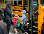 FILE - Portland Public Schools Superintendent Kimberlee Armstrong hands out pens to students at Woodlawn Elementary in northeast Portland, Ore., Aug. 27, 2024. 