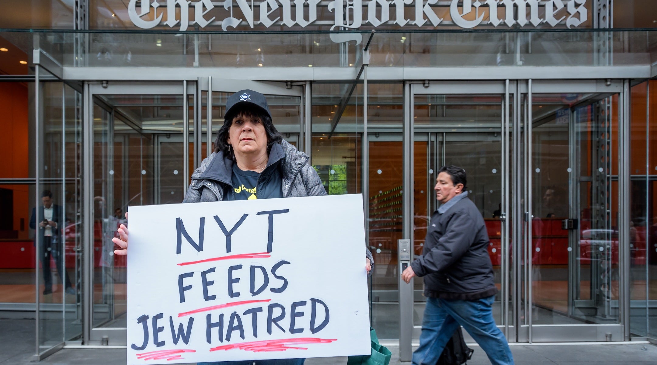 protester holds a sign reading 