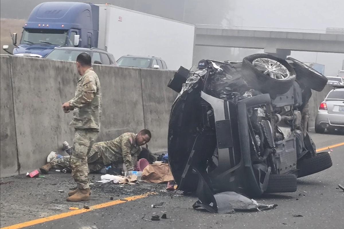 Woman allegedly stabs girl after SUV hits semi as soldiers step in to stop horrific roadside attack