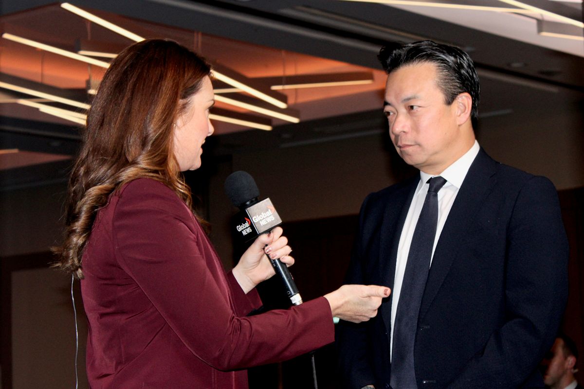 A photo of Ken Sim being interviewed