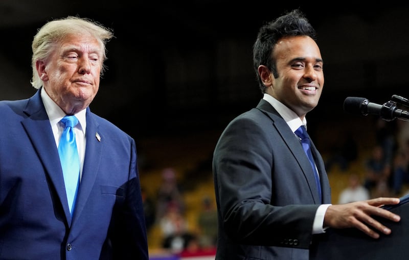 President Donald Trump listens as Republican gubernatorial candidate Vivek Ramaswamy speaks during a rally at Butler High School in Vandalia, Ohio, October 3, 2026.