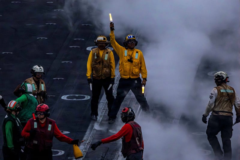 A U.S. Navy sailor directs aircraft on the flight deck of the Nimitz-class aircraft carrier USS Abraham Lincoln which is supporting U.S. military operations in the war with Iran, August 14, 2026.  U.S. Navy/Handout via REUTERS. THIS IMAGE HAS BEEN SUPPLIED BY A THIRD PARTY