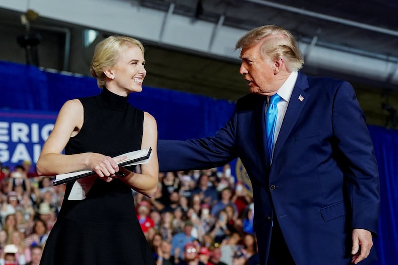President Donald Trump's Executive Assistant Natalie Harp receives an Executive Order from Trump after he signed it during a rally at Pinnacle Bank Expo Center in Grand Island, Nebraska, US, October 5, 2026. REUTERS/Nathan Howard