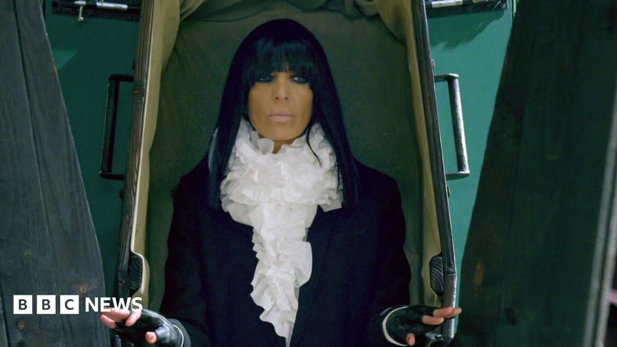 Claudia Winkleman emerging from a coffin