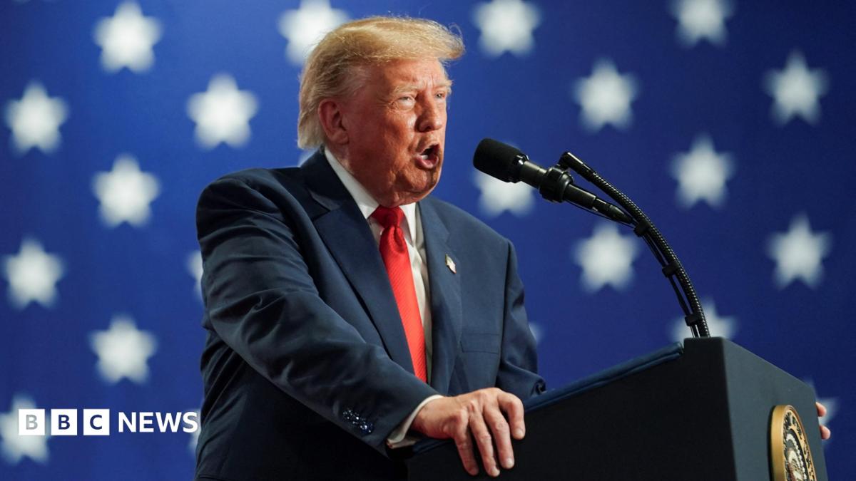 Donald Trump smiling broadly and holding up the Nobel Peace Prize