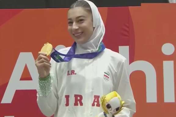 Saghar Moradi Sheikhlari celebrates with her gold medal after winning the women’s under-67kg taekwondo title.