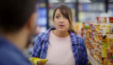 Actors playing a couple in a grocery store discuss inflation in a campaign ad