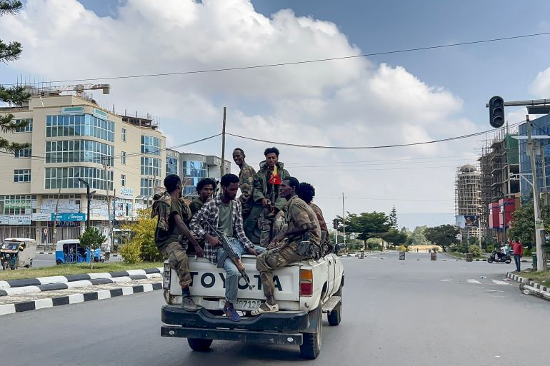 Members of the Ethiopian pro-government Tigray Peace Force (TPF) ride in a pickup truck while Ethiopian federal and allied forces enter the Tigray capital of Mekelle, October 4, 2026 [AFP]