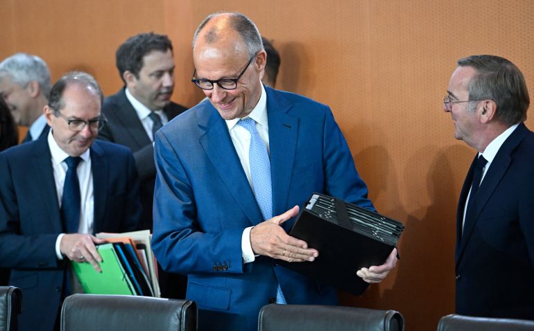 German Chancellor Friedrich Merz (C) arrives for the weekly cabinet meeting of the German government at the Chancellery in Berlin on October 7, 2026. (Photo by Tobias SCHWARZ / AFP)