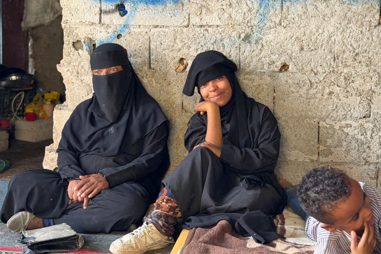 Members of a Yemeni family who were displaced from their homes with their families due to renewed clashes between Yemen's Saudi-backed government forces and the Houthis sit in a shop used as temporary shelter in Taiz province in southwestern Yemen on October 8, 2026.