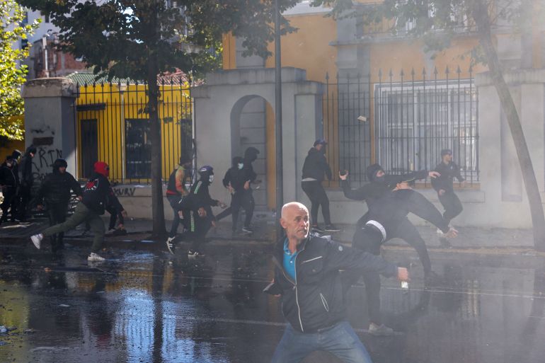 Protesters throw bricks at police during clashes in central Tirana on October 14, 2026, as violence erupted for a second consecutive day during demonstrations demanding the resignation of Albanian Prime Minister and better education.