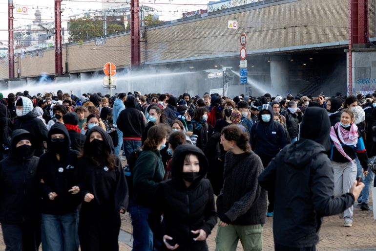 Riot police uses a water cannon against demonstrators in Brussels during a youth protest [Nicolas Maeterlinck/AFP]