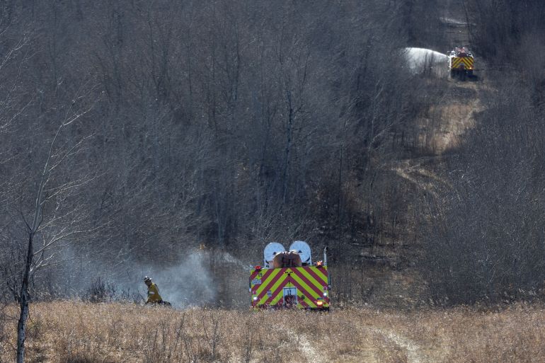 Firefighters continue to work close to Canadian Forces Base Wainwright in Wainwright, Alberta, Canada, on October 18, 2026.