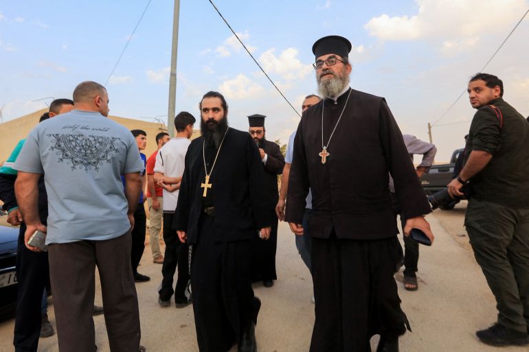 Greek Orthodox priests walk at the site of a shooting at the church in the village of Hammoud in Jordan’s Karak governorate on October 23, 2026 [AFP]