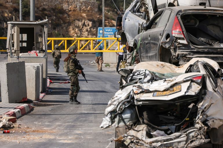 An Israeli soldier speaks with a driver at the blocked northern checkpoint in Hebron, in the occupied West Bank, on October 24, 2026.