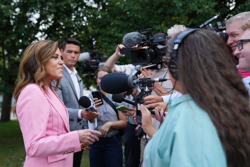 Michele Tafoya answers questions after voting in Minneapolis on August 11.