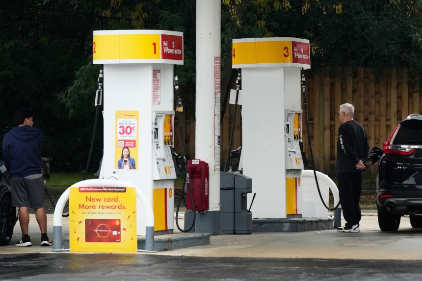 Customers fill up their vehicles at a gas station in Arlington Heights, Illinois, on September 30, 2026.