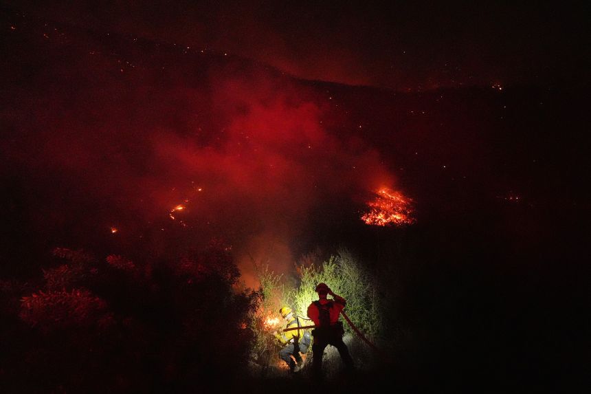 Crews make a stand in front of the Bryson Fire in Malibu, California, on Thursday, Oct. 15.