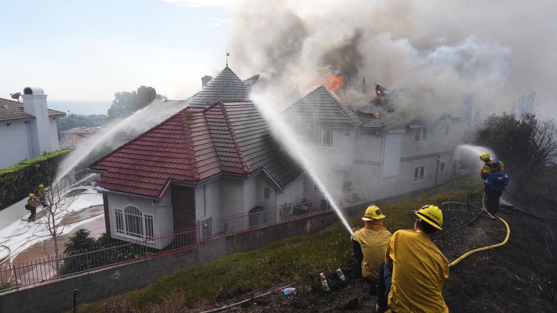 Southern California wildfire in explodes in size, burning multiple homes
