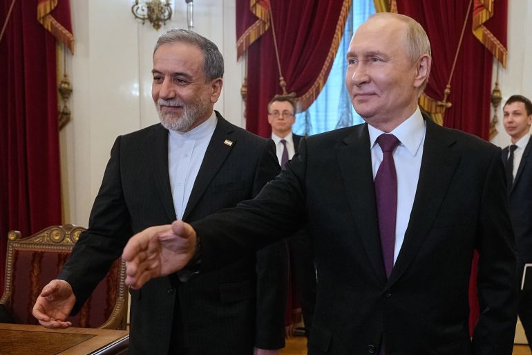 Russian President Vladimir Putin, right, and Iranian Foreign Minister Abbas Araghchi walk to attend the talks at the Boris Yeltsin Presidential Library, in St. Petersburg, Russia, Monday, April 27, 2026. (AP Photo/Dmitri Lovetsky, Pool)