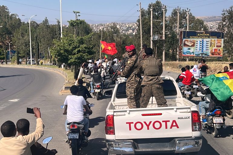 In this photo taken with a smartphone, soldiers participate in a procession welcoming former Tigray leader Getachew Reda in Mekelle, Ethiopia, Sunday, Oct. 11, 2026. (AP Photo/Filmon Equar Hailu)