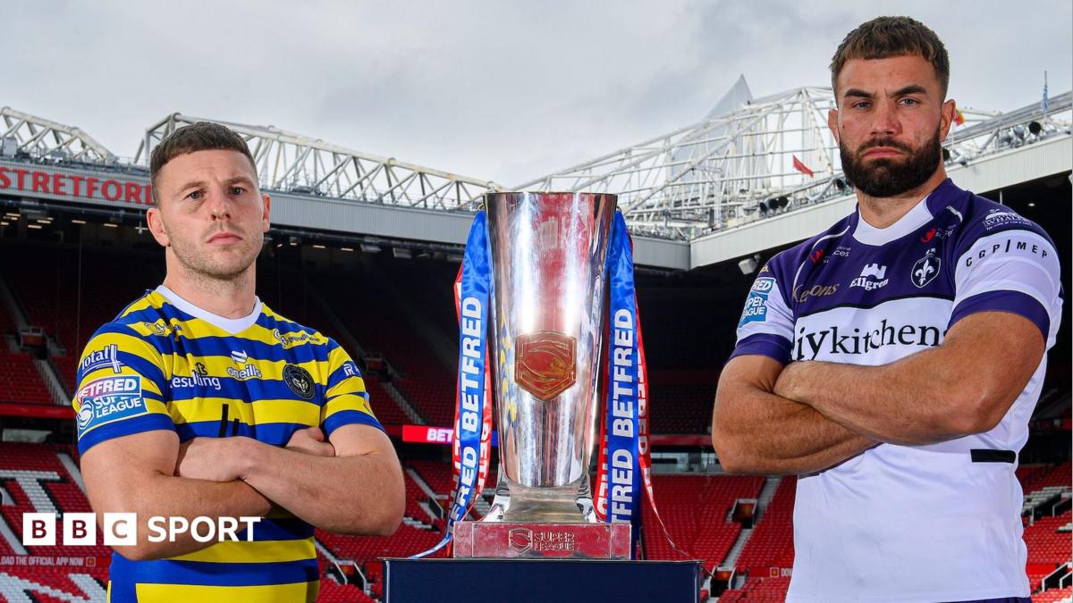 Warrington Wolves' George Williams and Wakefield Trinity's Mike McMeeken stand alongside the Super League trophy at Manchester United's Old Trafford
