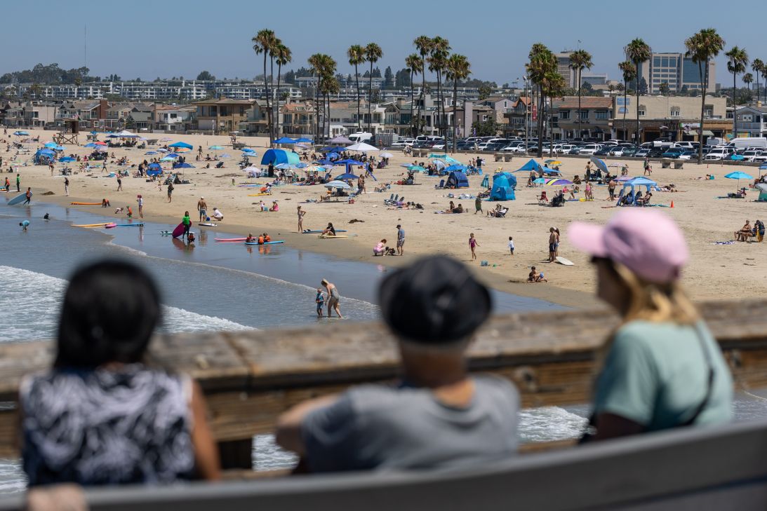 Beachgoers enjoy at day on the sand a few days after July 4 on Tuesday, July 7, in Newport Beach, California.