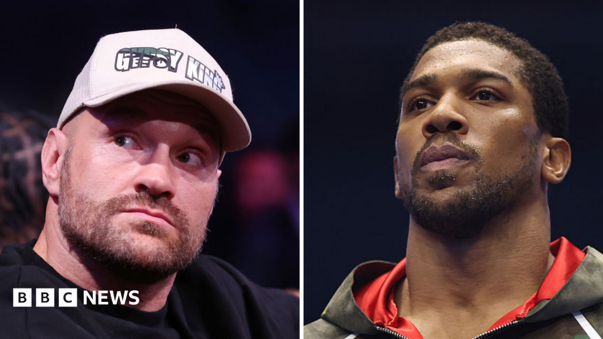 A composite image of Tyson Fury and Anthony Joshua. Tyson (left) wears a white boxing glove which is held in the air, and black shorts with the words 'Gypsy King' on. Joshua (right) is draped in a Union Jack flag and holds his fists up. He is wearing white boxing gloves.