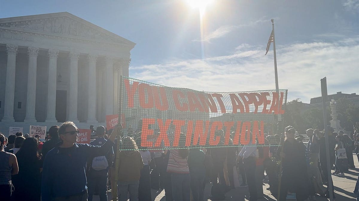 Climate activist protesters gather outside of the Supreme Court before oral arguments