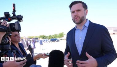 JD Vance talks with reporters on a tarmac