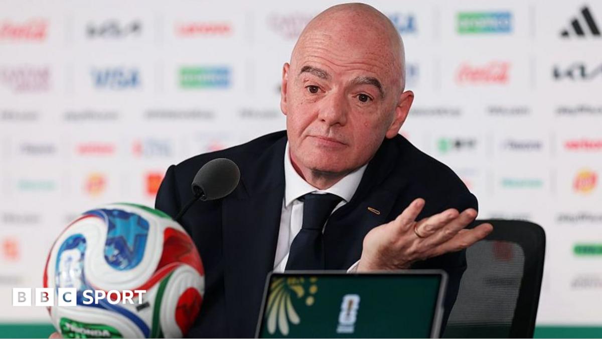 Gianni Infantino pictured at a news conference at the 2026 Fifa World Cup in front of a football.