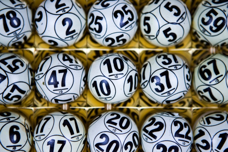 Overhead view of a set of lottery or bingo balls with numbers visible.