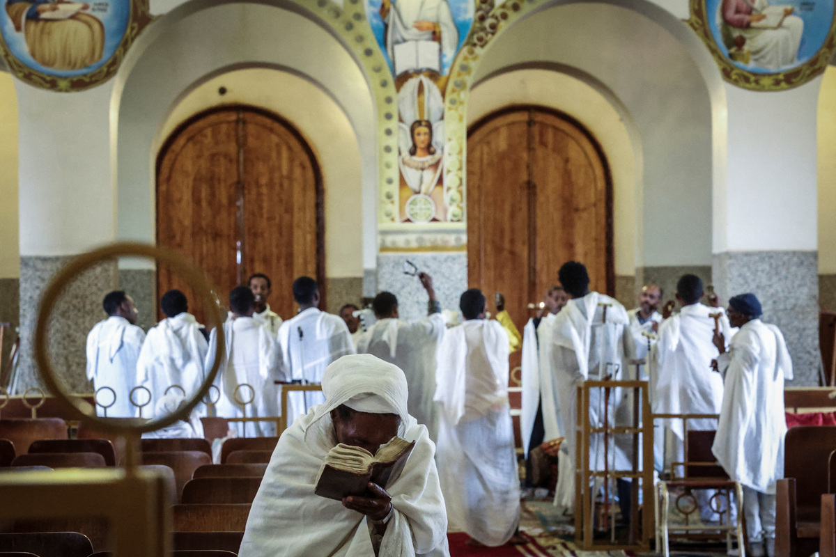 A woman reads a book inside the Orthodox Enda Mariam Cathedral, ahead of Martyrs' day, which commemorates the sacrifices made by Eritreans who lost their lives during the Eritrean War of Independence, in Asmara , Eritrea, June 19, 2026. Eritrea has long been isolated by the West, which views the East African country as among the most repressive in the world, while the government in Asmara has itself pursued a policy of political and economic seclusion. Despite its small population, Eritrea has gained new geopolitical importance this year, during the Iran war, because of its 1,000-km Red Sea coastline along a key shipping route between the Mediterranean and Asia. As conflict disrupted traffic through the Strait of Hormuz and attacks by Iran-backed Houthi militants threatened vessels near Yemen, Eritrean waters emerged potentially as one of the safest corridors for maritime trade. REUTERS/Monicah Mwangi