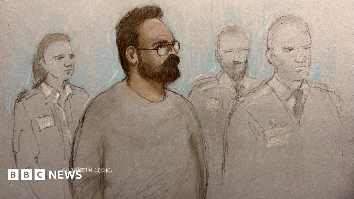 A court sketch of Joshua Kerry, surrounded by three guards. He has a beard and wears glasses.