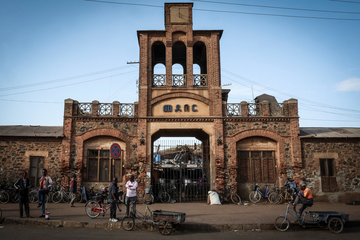 People stand with bicycles outside the Medeber Market, an open-air recycling and craft market in downtown Asmara, Eritrea, June 22, 2026. Eritrea has long been isolated by the West, which views the East African country as among the most repressive in the world, while the government in Asmara has itself pursued a policy of political and economic seclusion. Despite its small population, Eritrea has gained new geopolitical importance this year, during the Iran war, because of its 1,000-km Red Sea coastline along a key shipping route between the Mediterranean and Asia. As conflict disrupted traffic through the Strait of Hormuz and attacks by Iran-backed Houthi militants threatened vessels near Yemen, Eritrean waters emerged as potentially one of the safest corridors for maritime trade. REUTERS/Monicah Mwangi