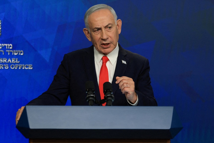 Benjamin Netanyahu giving a press conference at a podium.