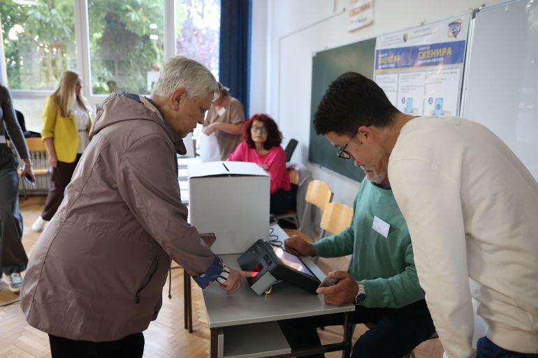 epa13280081 A voter identifies himself using an optical scanner at a polling station during the general election in Sarajevo, Bosnia and Herzegovina, 04 October 2026. Citizens across Bosnia and Herzegovina are voting to elect members of the country's tripartite presidency alongside national, entity, and cantonal representatives. The election also marks the first nationwide use of biometric fingerprint identification and ballot scanners to combat fraud. EPA/HAZIM ALJOVIC BOSNIA AND HERZEGOVINA OUT