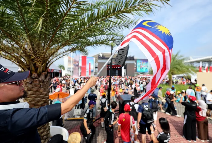 Fan waves Malaysian flag