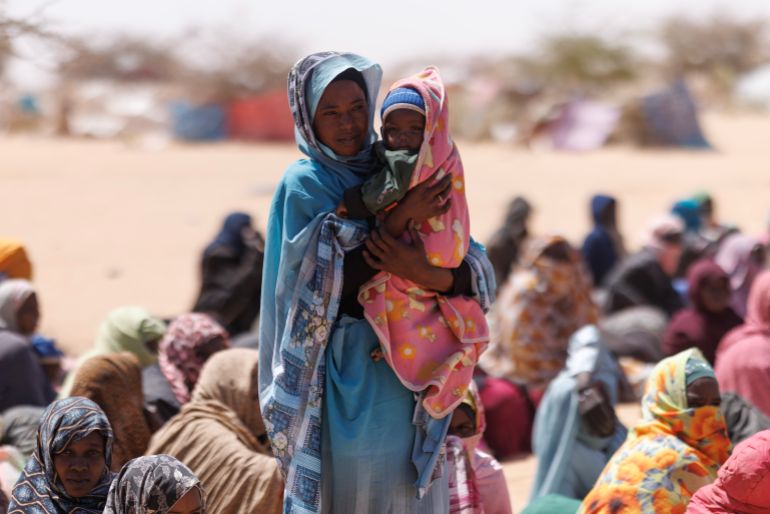 OURE CASSONI, CHAD - FEBRUARY 24: Sudanese refugees wait to be given plastic sheets and other food aid at the Oure Cassoni refugee camp after arriving from Sudan, on February 24, 2026 in Oure Cassoni, Chad. In April 2023 civil war erupted between the Sudanese Armed Forces (SAF) and the armed militia group Rapid Support Forces (RSF). The ongoing conflict has so far displaced around 14 million people across the region, triggering a widespread humanitarian crisis, as neighboring countries like Chad struggle to absorb refugees, while coping with populations already suffering high poverty rates and food insecurity. Chad has become Africa's largest host of refugees per capita, hosting a total 1.4 million refugees - more than 900,000 of which fled the conflict in Sudan. The most recent wave of arrivals from Sudan follows the RSF's offensive to capture the north Darfur city of El Fasher, where 6,000 people were reportedly killed by the RSF in the space of three days in October. A recent UN report has accused the RSF of atrocities that amount to war crimes and possible crimes against humanity. As many as 400,000 people have reportedly been killed since the conflict began. (Photo by Dan Kitwood/Getty Images)